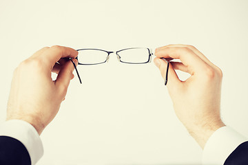 Image showing man hands holding eyeglasses