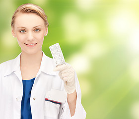 Image showing happy female doctor with pills