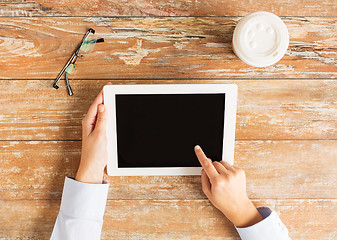 Image showing close up of female hands with tablet pc and coffee