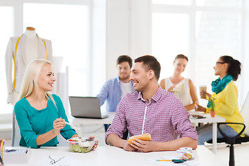 Image showing smiling fashion designers having lunch at office