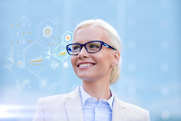 Image showing young smiling businesswoman in eyeglasses outdoors