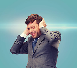 Image showing stressed buisnessman or teacher closing ears