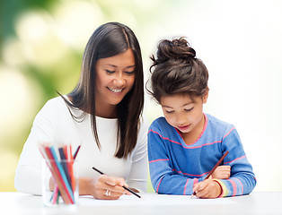 Image showing happy mother and daughter drawing with pencils