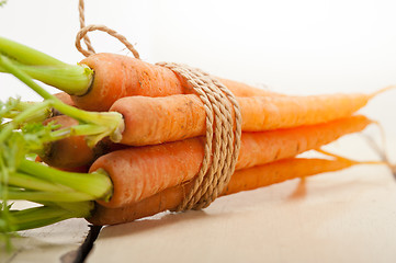 Image showing baby carrots bunch tied with rope