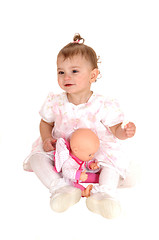 Image showing Baby girl playing with dolly.