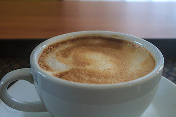 Image showing cappuccino coffee on wooden table