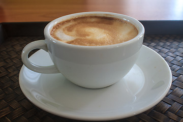 Image showing cappuccino coffee on wooden table