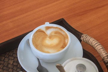 Image showing cappuccino coffee on wooden table