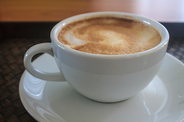 Image showing cappuccino coffee on wooden table