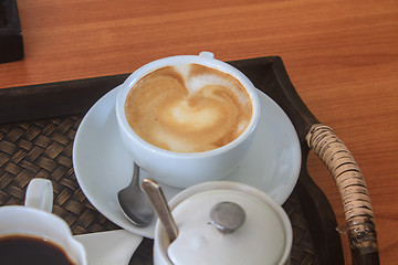 Image showing cappuccino coffee on wooden table