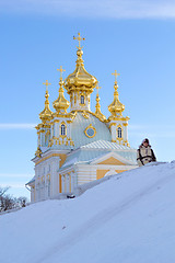 Image showing young women near beautiful church in winer. Petergof, St. Petersburg, Russia