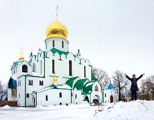 Image showing Girl take show fun near Orthodox Theodore's russian church in winter day