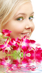 Image showing lovely blond with orchid in water