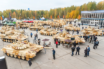 Image showing Visitors explore military vehicles on exhibition