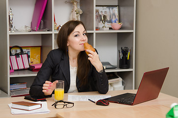 Image showing Girl in the office at lunchtime