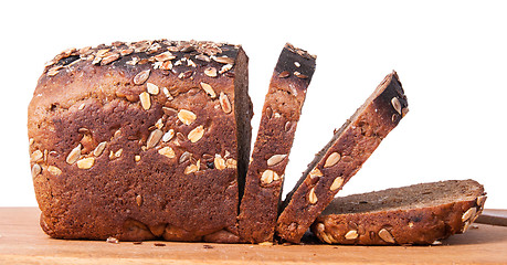 Image showing Unleavened bread with seeds sliced on cutting board