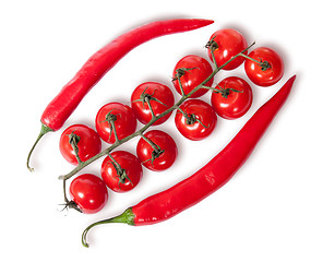 Image showing Two chili pepper and cherry tomatoes on stem top view