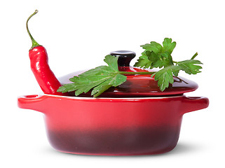 Image showing Red pepper in saucepan with lid and parsley on top