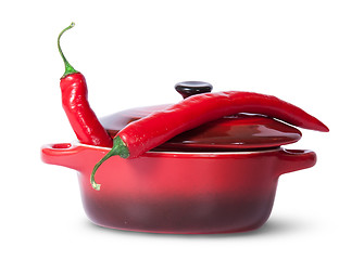 Image showing Two red chili peppers in saucepan with lid