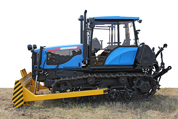 Image showing Blue building bulldozer tractor on grass 