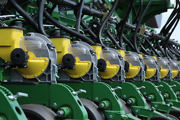 Image showing tractor and seeder planting crops on a field