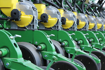 Image showing tractor and seeder planting crops on a field