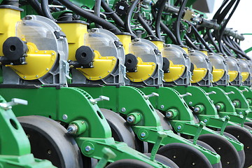 Image showing tractor and seeder planting crops on a field