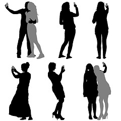 Image showing Silhouettes  man and woman taking selfie with smartphone on whit