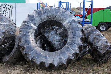 Image showing wheels of tractors tire and farm equipment in the package.