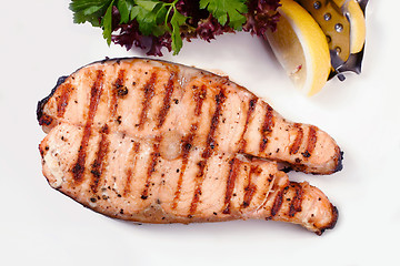 Image showing Grilled salmon steak with salad and lemon