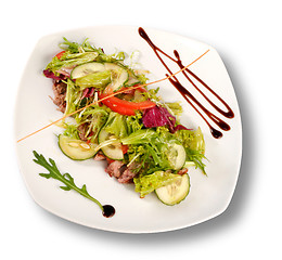 Image showing A plate of pork with vegetables. File includes clipping path for