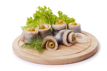 Image showing A composition with marinated herring rolls