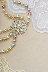 Image showing Necklace with brooch on lace background