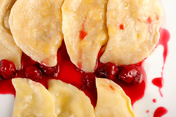 Image showing Ukrainian national dish varenyky (ravioli) with cherry closeup