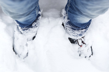 Image showing Snowy mountain shoes with blue jeans