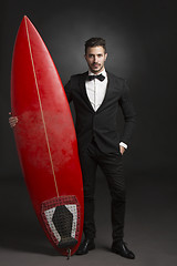 Image showing Latino young man with a surf board