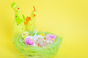 Image showing Easter eggs in nest and chickens