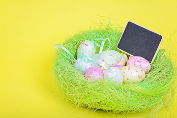 Image showing Ester eggs in nest with copy-space blackboard