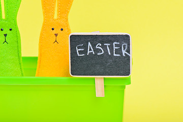 Image showing Easter Bunnies in flower pot with black board