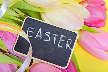 Image showing Easter ribbon, tulips and small blackboard