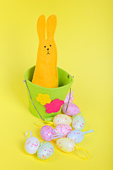 Image showing Easter rabbit in bucket on yellow