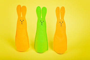 Image showing Three easter Bunnys on yellow