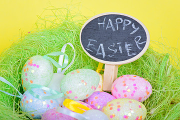 Image showing Ester eggs in nest with small chalkboard