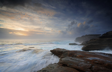 Image showing Wild ocean surges over steadfast rocks