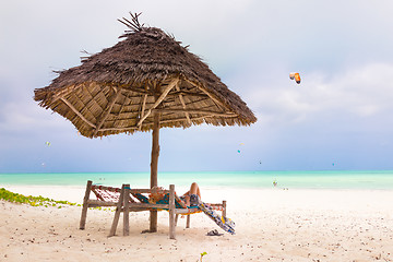 Image showing Woman sunbathing on tropical beach.