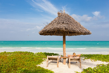 Image showing Woman sunbathing on tropical beach.