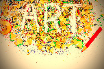 Image showing ART word on the background of colored pencil shavings