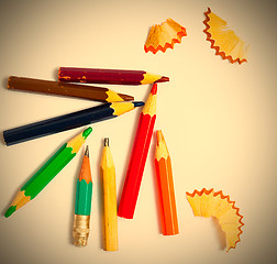 Image showing several vintage pencils and shavings on a white