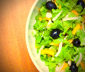 Image showing Assorted salad of green leaf lettuce with squid and black olives