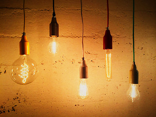 Image showing Light bulbs decorating a concrete wall